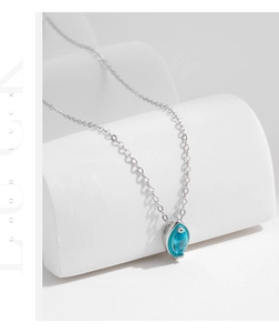 Macro detail of S925 sterling silver necklace featuring a marquise cut sky blue stone pendant