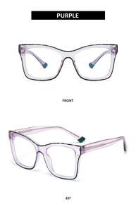 Detail view of purple translucent eyeglasses frame with reinforced metal core temple
