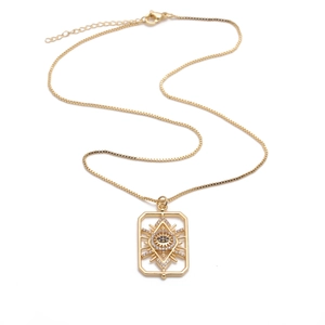 Detail of gold evil eye rectangular pendant with sparkling zircon inlays on box chain