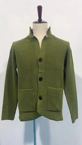 Detail view of the grass green waffle knit texture and button closure on the cardigan