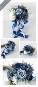 Close-up of dusty blue artificial wedding bouquet with silk roses and satin ribbons