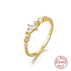 Detailed macro view of S925 sterling silver stamp on golden engagement ring with clear gems