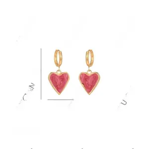 Pink heart earrings with gold edges and dimensions detail, size 3.6cm by 1.7cm
