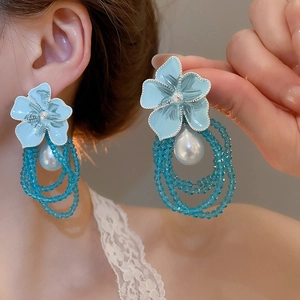 Close-up of French tulle floral earrings with crystal beads and a teardrop pearl drop