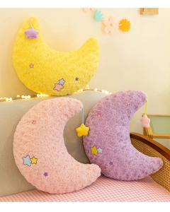 Detailed view of crescent moon plush pillows with rose texture and star embroidery