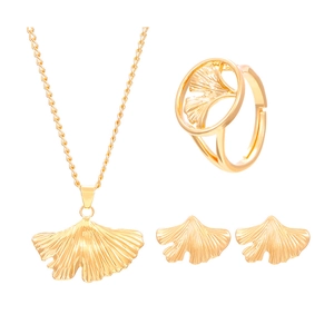 Golden ginkgo leaf jewelry set with necklace, ring and earrings on a white background