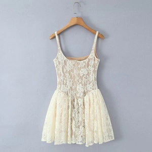 Detail of elegant cream lace dress with pink lining and delicate floral embroidery