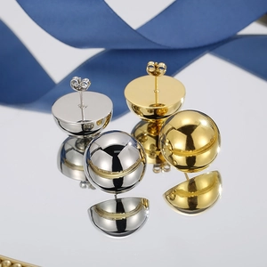 Polished gold and silver stainless steel ball stud earrings on reflective blue surface