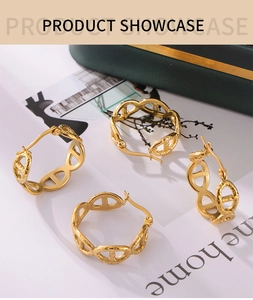 Macro detail of 18k gold plated oval hollow earrings with textured surface on jewelry box