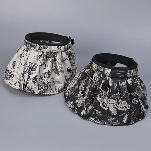 Detail of wide brim sun visors with elegant vintage Toile de Jouy landscape pattern print