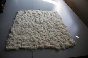 Close-up of thick white faux silk moss lawn showing dense plush texture and weave