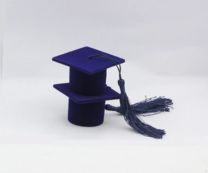 Close-up of dark blue flocked graduation cap jewelry box with matching silk tassel