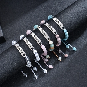 Detailed view of adjustable natural stone beaded bracelets with engraved metal bars