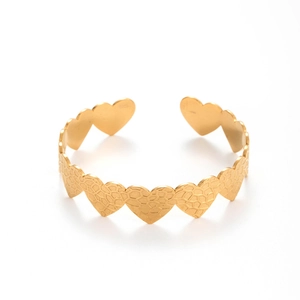 Gold stainless steel open bangle featuring textured honeycomb heart-shaped links