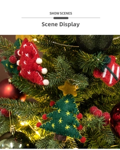 Detailed view of handmade wool felt Christmas tree ornaments hanging on festive branches