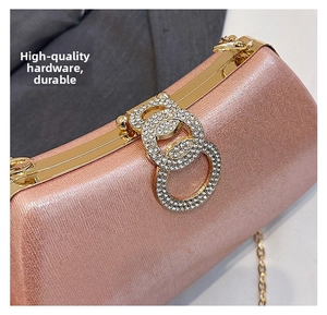 Detail of rose gold evening clutch featuring sparkling texture and diamond-set double ring clasp
