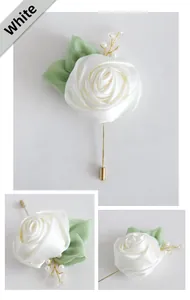 Detail of handmade white satin rose boutonniere with pearls and gold pin for wedding suit