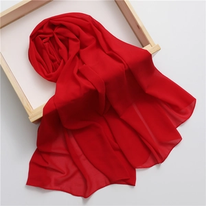Vibrant red pearl chiffon long scarf and pashmina shawl for women on a wooden tray