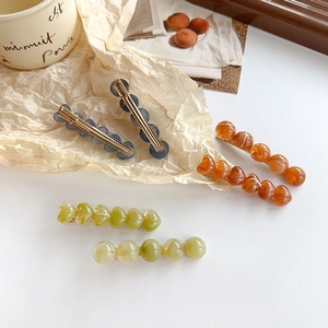 Set of jelly-colored heart resin hair clips with golden metal duckbill pins for women