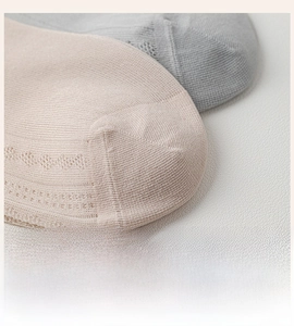 Close-up of seamless toe stitching on breathable thin mesh socks with bow detail