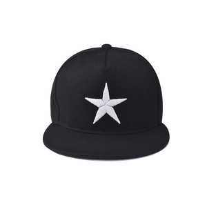 Detailed close-up of white five-pointed star embroidery on a black cotton snapback hat