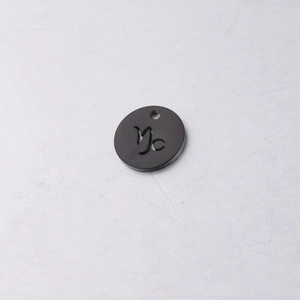 Macro detail of 12mm matte black titanium steel Capricorn zodiac charm for DIY jewelry