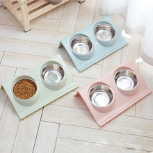 Detail view of double pet bowls in blue, green, and pink with stainless steel inserts