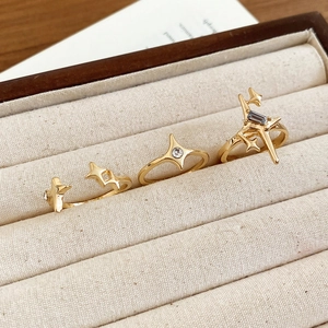 Detailed view of three gold star rings with blue and white zircon in a jewelry box