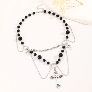 Detail of multi-layer necklace with black beads, silver thorns chain, and cross pendants