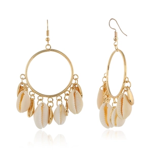 Detailed view of natural shell pendant earrings with large gold hoops on white background