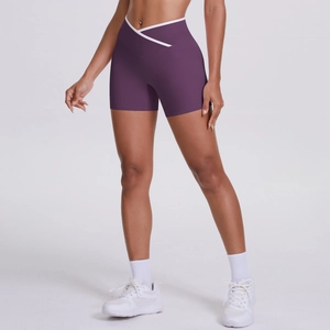 Detail of high waisted cross V-waist yoga shorts in deep purple with white piping trim