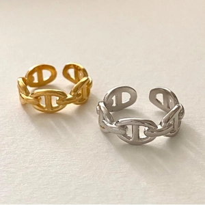 Close-up of gold and silver knot rings in 925 sterling silver anchor chain design