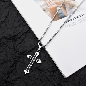 Detail of gothic cross necklace with black inlay and stainless steel pearl chain