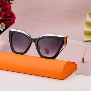 Cat eye sunglasses with tricolor frame and purple gradient lenses on orange case