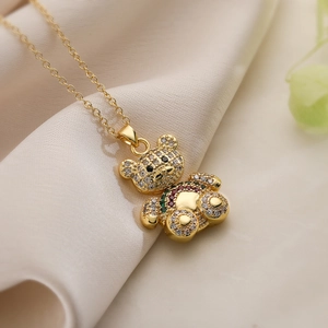 Gold plated teddy bear necklace with zircon stones and pearls on silk base