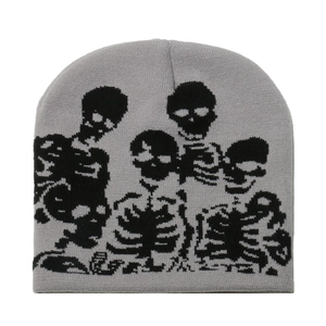 Light gray knit beanie featuring a black skull jacquard pattern on a white background