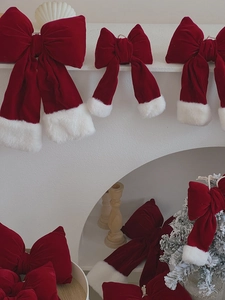 Detail of red velvet Christmas bows with white faux fur trim for festive home decoration