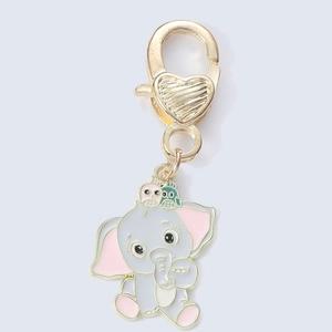 Detail of grey elephant and owls metal pendant keychain with golden heart clasp