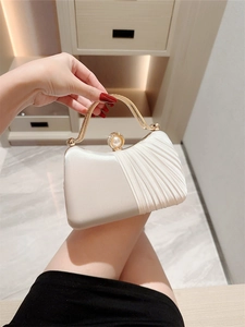 Elegant cream satin evening bag with pearl clasp and gold handle for formal parties