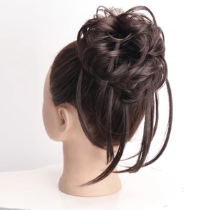 Messy fluffy dark brown bun hair extension with long tendrils on mannequin head