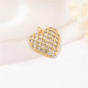 Exquisite gold heart pendant with micro-pave crystals on soft white mesh background