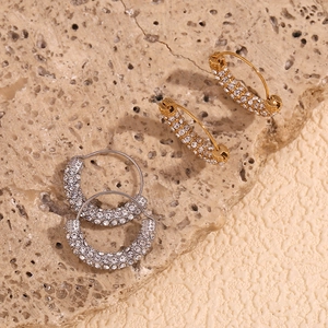 Close-up of gold and silver plated hoop earrings with micro-pave white zircon crystals
