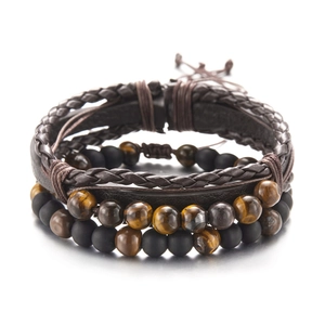 Detail of men's leather wrap bracelet set with tiger eye and matte black beads