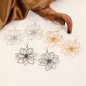 Three-color floral wire weave rings in gold, silver, and gun black on vintage background