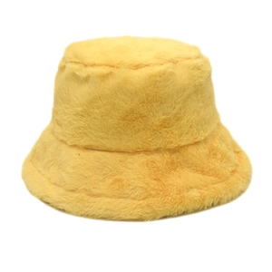 Close-up of the plush faux fur texture on a warm yellow winter bucket hat for women