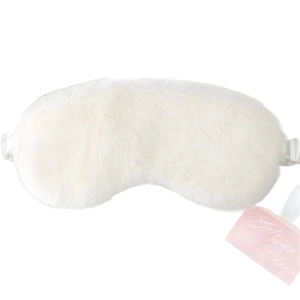 Soft white faux rabbit fur sleep mask with Get Some Sleep tag for travel use