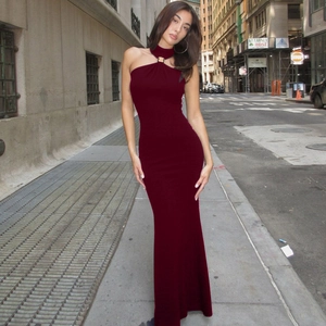 Detail of burgundy halter neck dress with metallic buckle on the collar and side slit