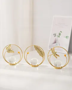 Detailed view of metal butterfly leaf and dragonfly figurines with crystal ball bases