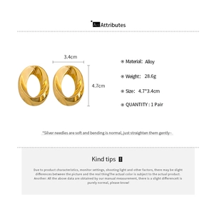Detailed view of geometric gold oval twist earrings with silver needle material and dimensions