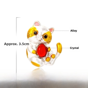 Detail view of a cat brooch with red crystal, measuring 3.5cm by 2.7cm, made of alloy